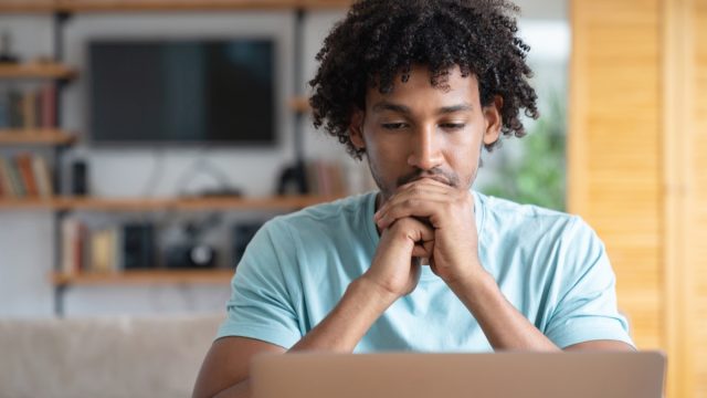 Portrait of a thoughtful worried man working online at home - lifestyle concepts