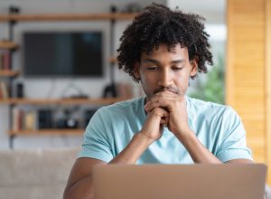 Portrait of a thoughtful worried man working online at home - lifestyle concepts