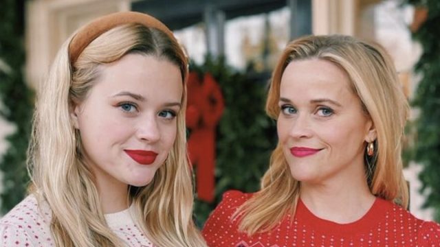 reese witherspoon and ava phillippe pose in matching draper james holiday sweaters