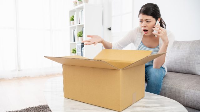 Woman is talking to the online customer service, she is unsatisfied with her parcel and complaining with them
