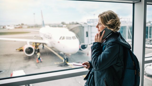 Woman using phone at the airport at the international airport