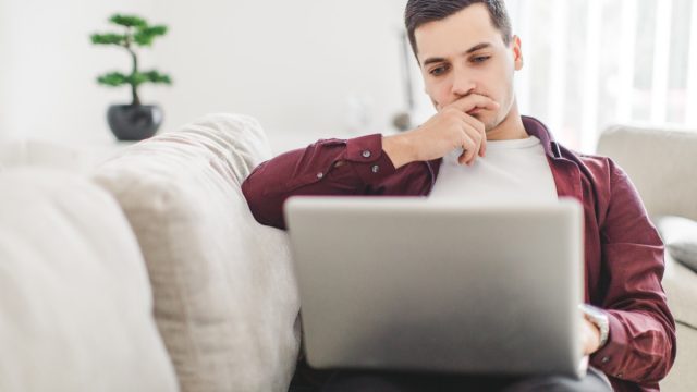 Man working on laptop looking for stimulus check