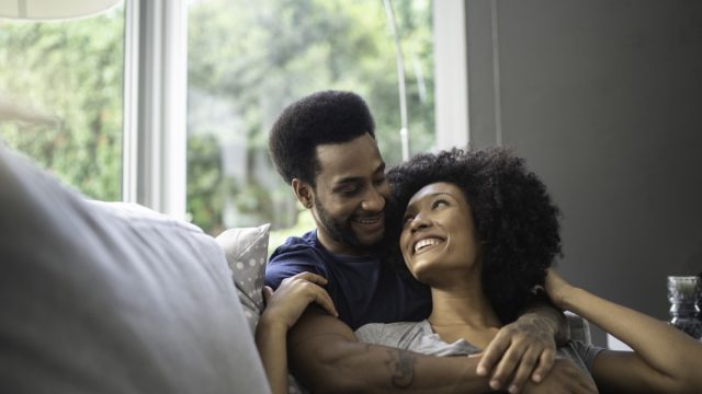 couple lying down and having romantic moment on couch