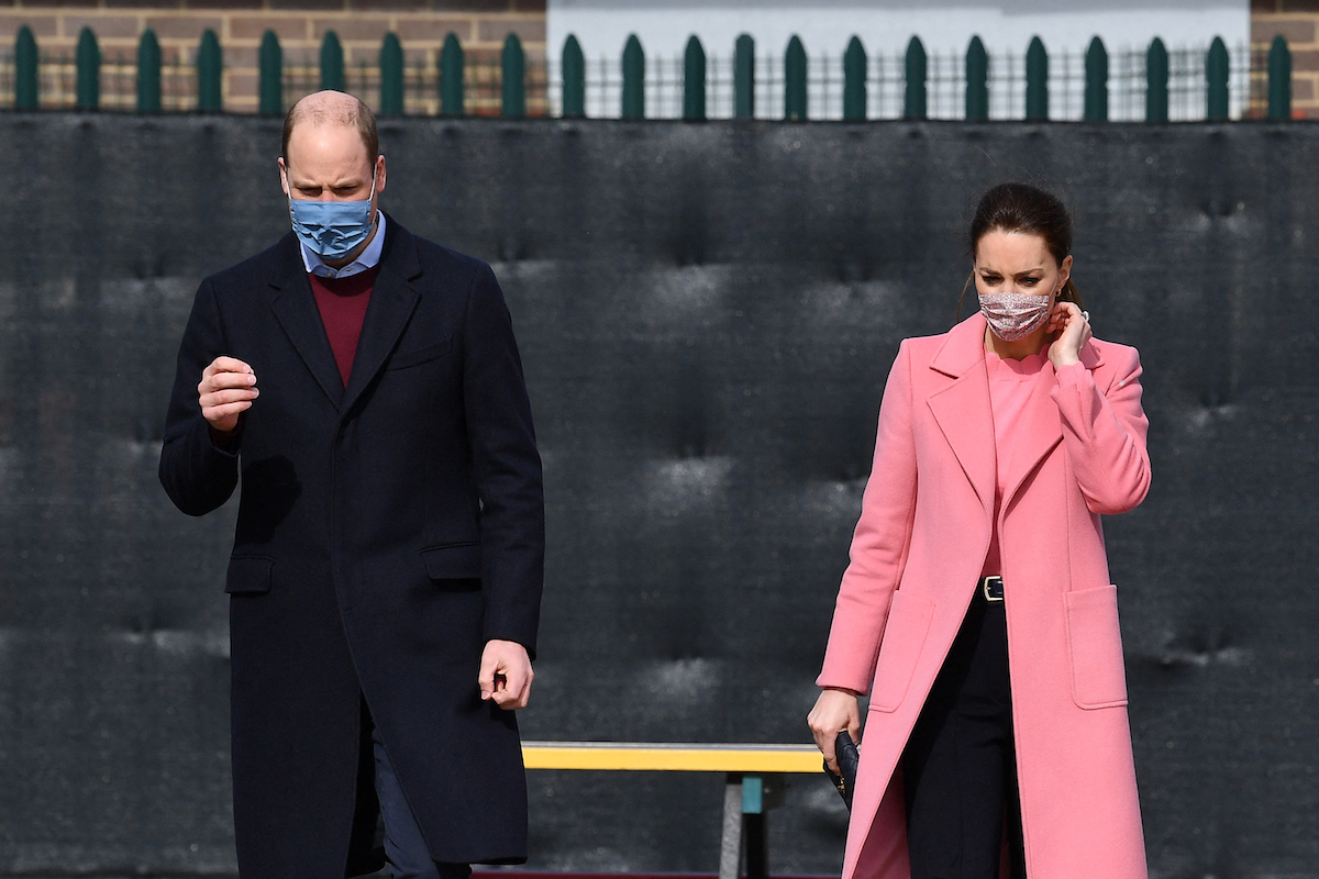 Prince William, Duke of Cambridge and Britain's Catherine, Duchess of Cambridge gesture during a visit to School21 following its re-opening after the easing of coronavirus lockdown restrictions in east London on March 11, 2021.