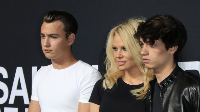 Brandon Lee, Pamela Anderson, and Dylan Lee at a Saint Laurent fashion show in Hollywood in 2016