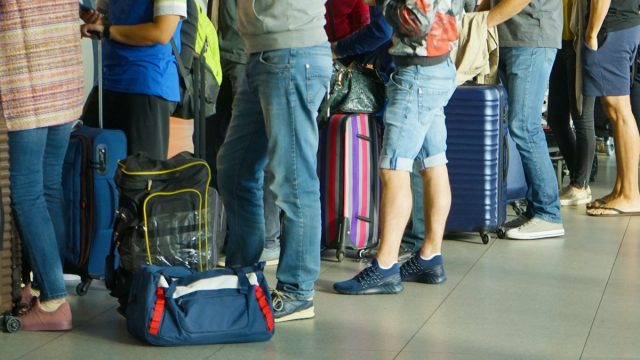Passengers waiting at airport gate
