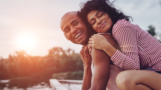 happy couple hugging outside