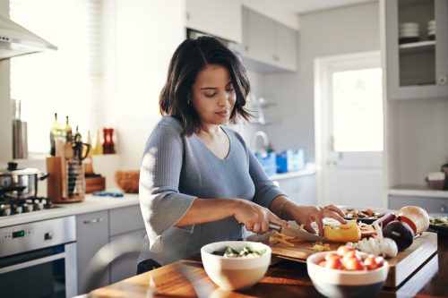 Shot of a woman cooking dinner at home