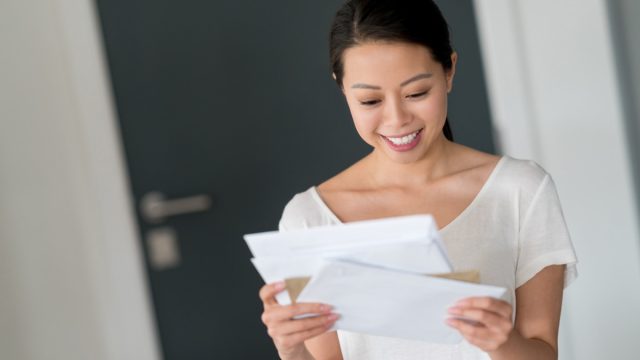 woman at home checking her mail and looking very happy - lifestyle concepts