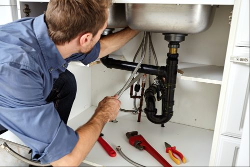 plumber working on pipe