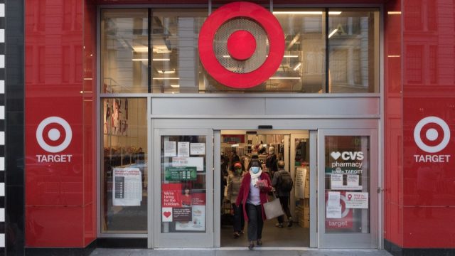 Manhattan, New York. November 20, 2020. A woman wearing a mask exits a Target store in Midtown.