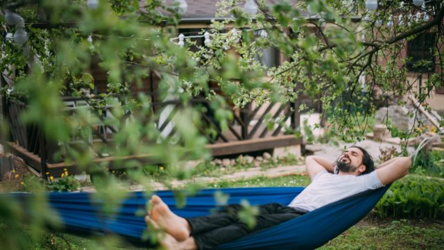 Man on a hammock in the backyard
