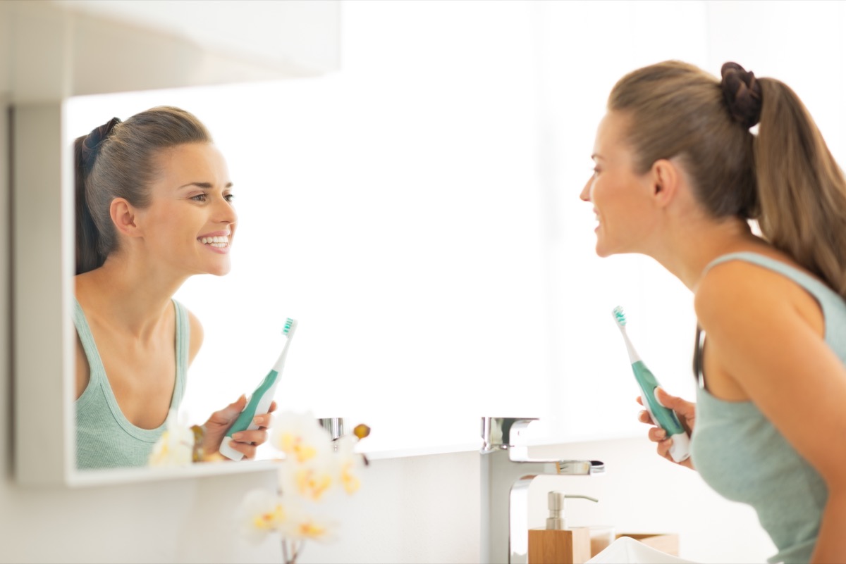 Woman done brushing her teeth