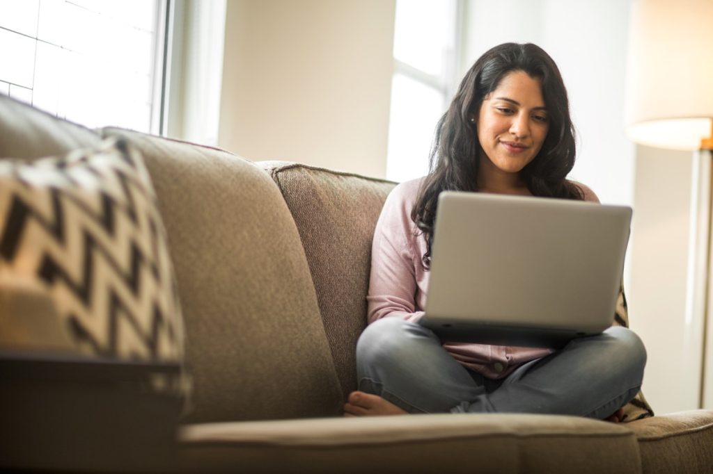 woman working on a laptop doing her budget.