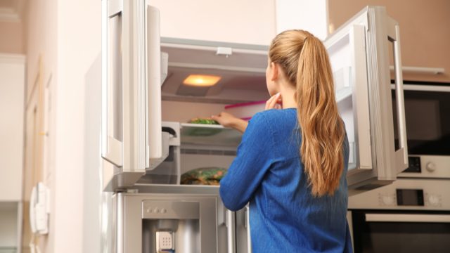 Woman looking in the freezer