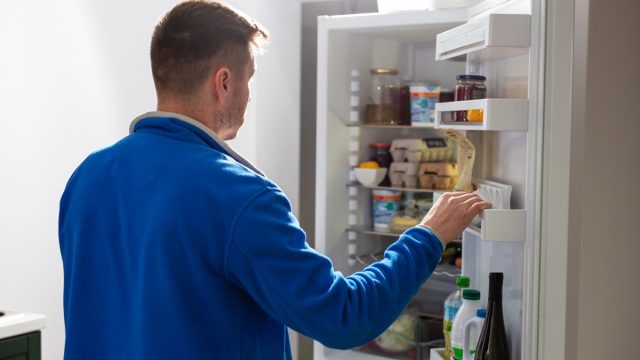 Man looking in refrigerator