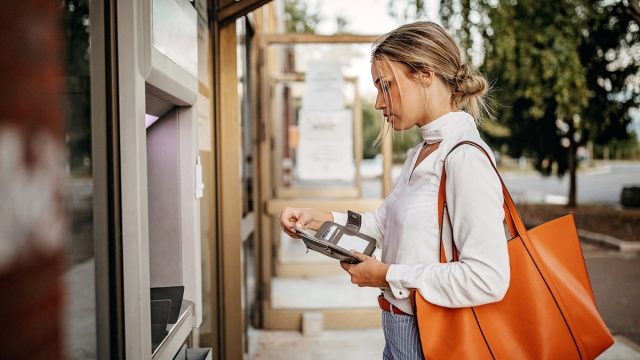 Women using ATM machine to withdraw money
