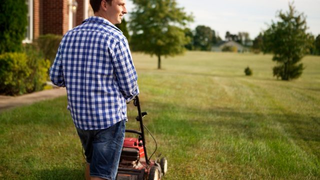 Man takes care of the garden around the house. At Virginia, USA.