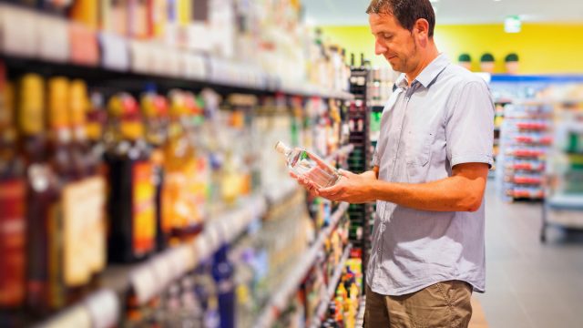 Man buying liquor at the supermarket