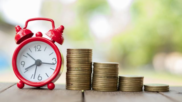 Retirement time line with clock and stacks of coins