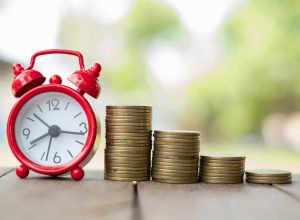 Retirement time line with clock and stacks of coins
