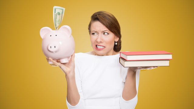 Cost,Of,College,Education.,Portrait,Stressed,Woman,Balancing,Piggy,Bank