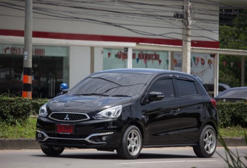 A black Mitsubishi Mirage on the road