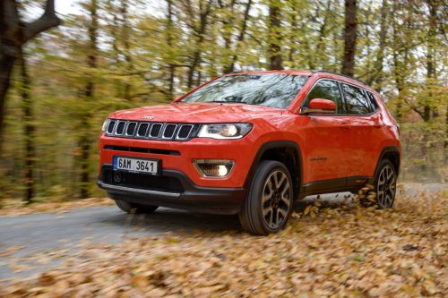 an orange Jeep Compass car driving