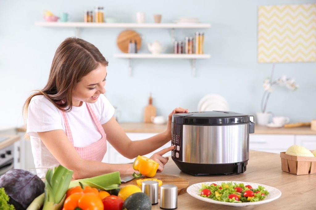Woman using multi cooker