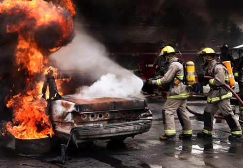 fire fighters putting out a car fire
