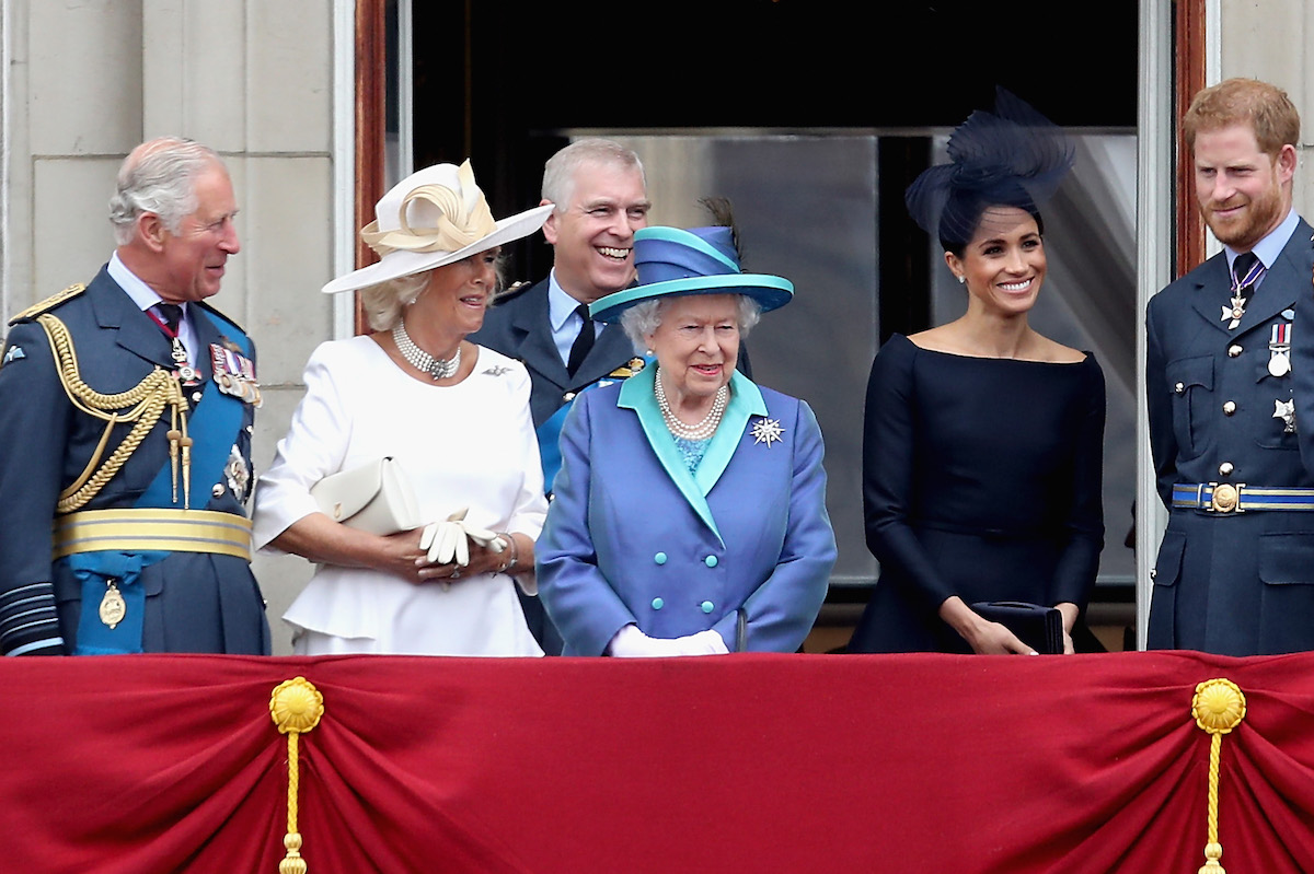 Prince Charles, Prince of Wales, Prince Andrew, Duke of York, Camilla, Duchess of Cornwall, Queen Elizabeth II, Meghan, Duchess of Sussex, and Prince Harry, Duke of Sussex, watch the RAF flypast on the balcony of Buckingham Palace, as members of the Royal Family attend events to mark the centenary of the RAF on July 10, 2018 in London, England
