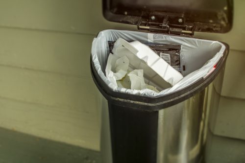 Household trash concept to throw away and be wasteful of garbage going into the landfill.