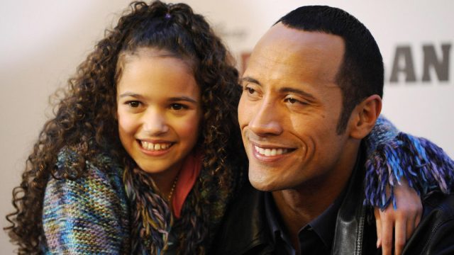 Dwayne Johnson, aka "The Rock" and Madison Pettis pose for photographers at a photo call for the film "The Game Plan" in Berlin on March 5, 2008.