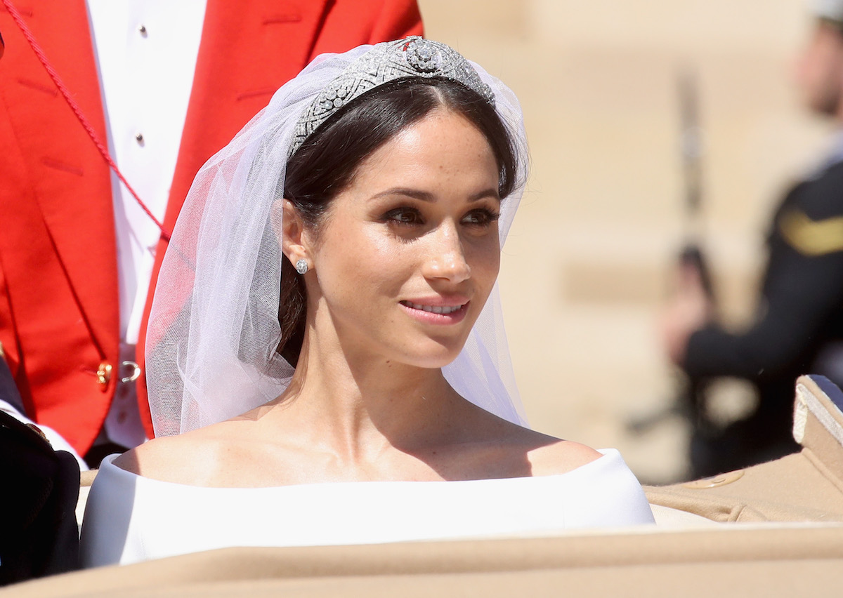 Prince Harry, Duke of Sussex and Meghan, Duchess of Sussex leave Windsor Castle in the Ascot Landau carriage during a procession after getting married at St Georges Chapel on May 19, 2018 in Windsor, England.