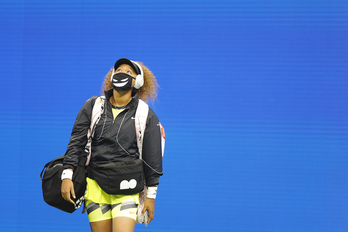 Naomi Osaka of Japan walks out onto the court to warm-up against Marie Bouzkova of Czech Republic during their women's singles first round match on Day One of the 2021 US Open at the Billie Jean King National Tennis Center on August 30, 2021 in the Flushing neighborhood of the Queens borough of New York City.