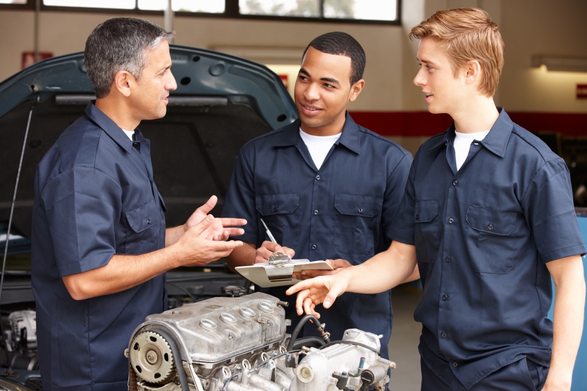 three mechanics talking 