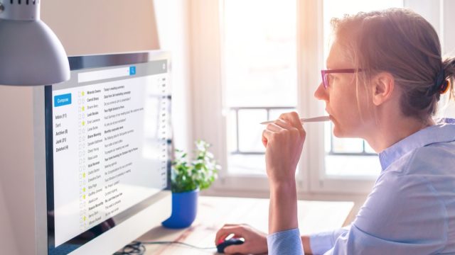 woman reading email at desk
