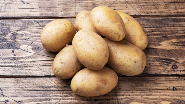 Potatoes on wooden table