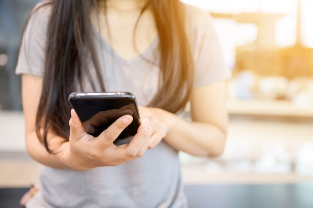 Close up image hand of woman using her mobile smartphone