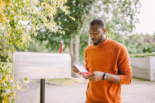 man receiving mail-in voting ballot.