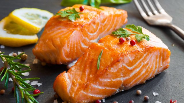 cooked salmon filets on a black slate slab