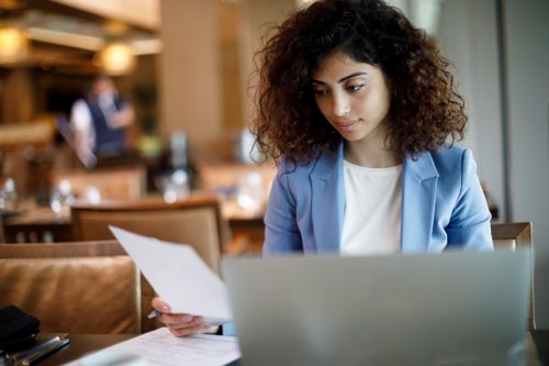 Businesswoman working on laptop at a cafe
