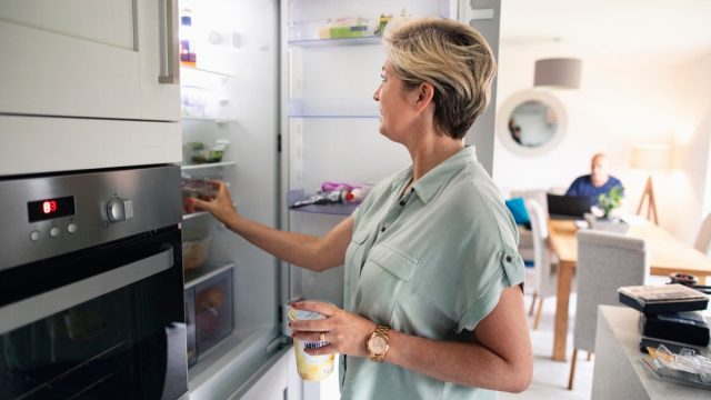 Reaching into Her Refrigerator
