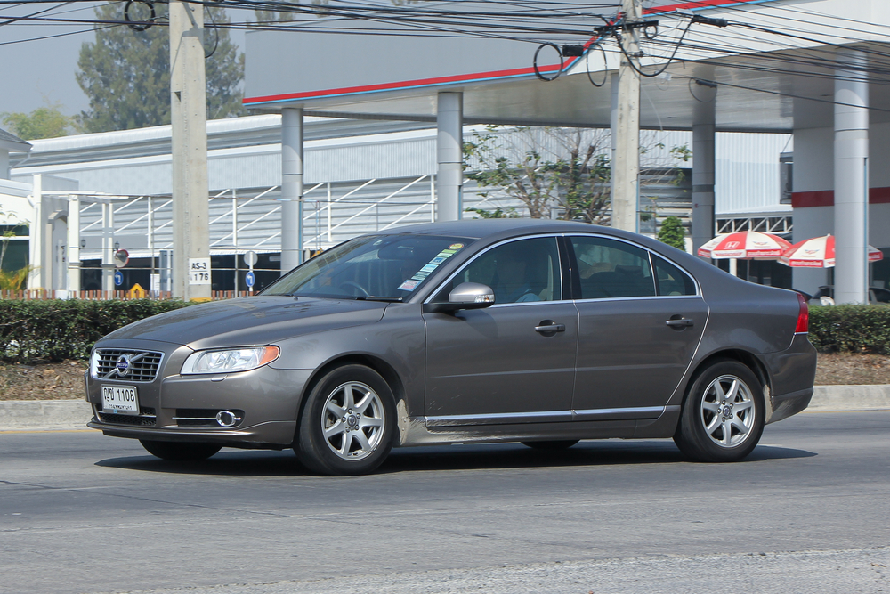A Volvo S80 sedan driving on a road