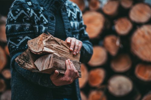 Man holding some firewood
