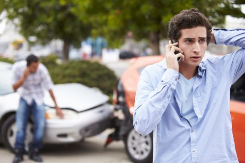 Driver making call after car accident