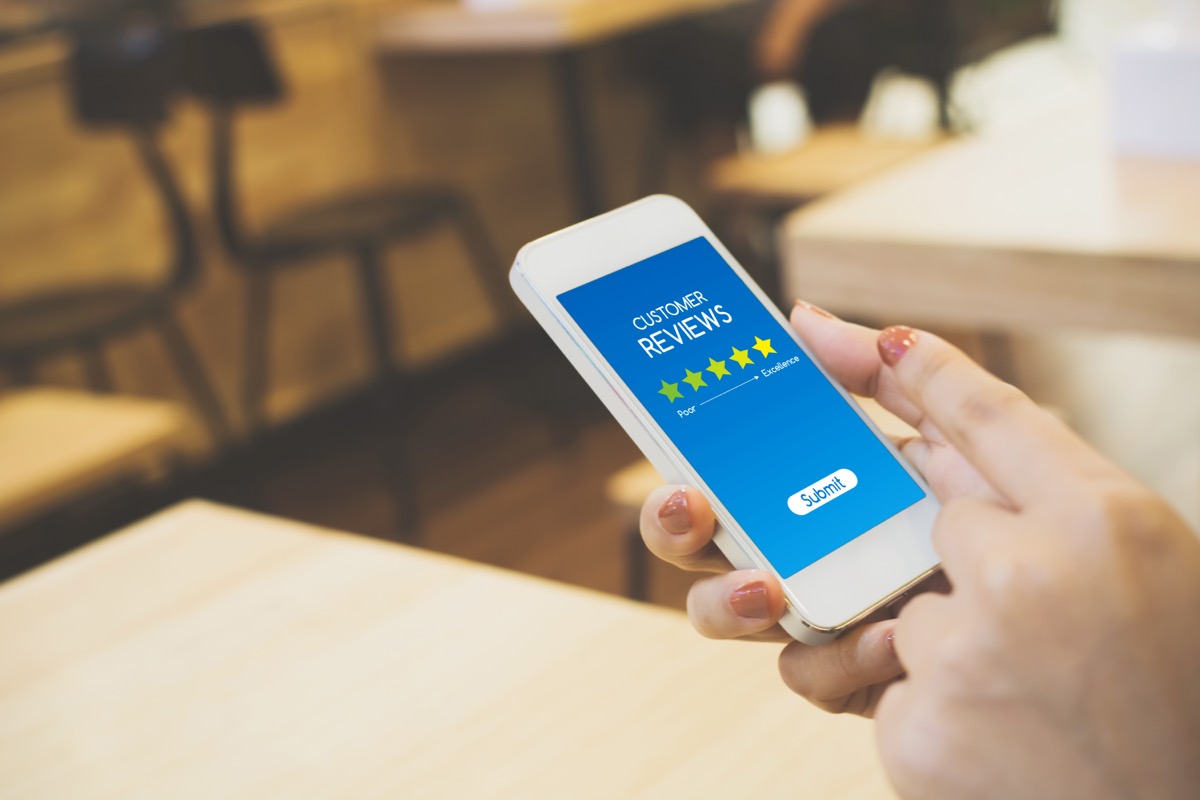person reading customer reviews on phone