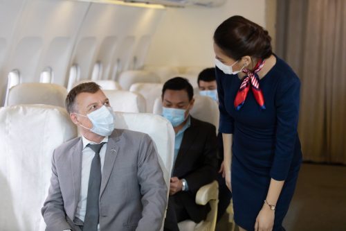 Flight attendant talking to passenger