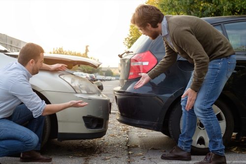 Two men talking after car accident