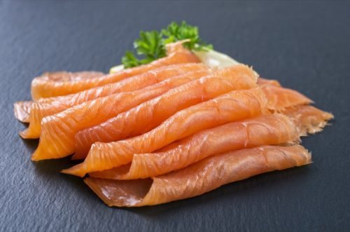 smoked salmon on black backdrop